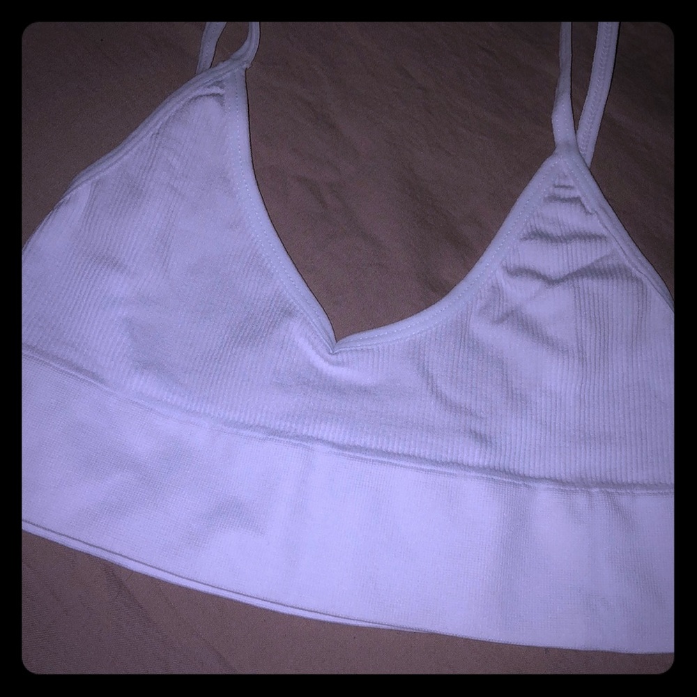 Brand new in package. White sports style bralette.